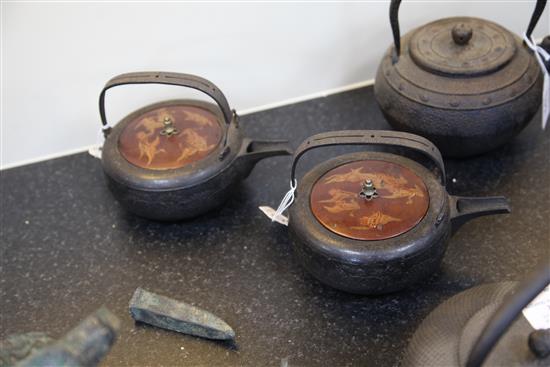 Five Japanese cast iron teapots, two with lacquer covers, 19th century, largest 19cm wide